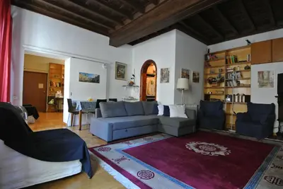 a living room with a blue couch and a rug at Centro Storico - Piazza di Spagna in Rome