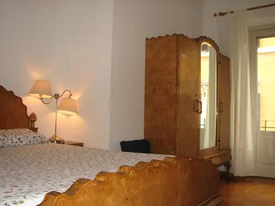 a bedroom with a bed and a large wooden cabinet at Centro Storico - Piazza di Spagna in Rome