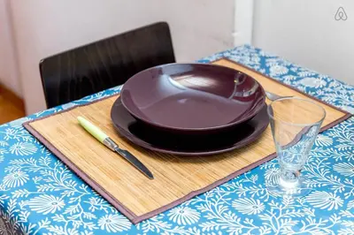 a wooden cutting board with a plate and a glass at Centro Storico - Piazza di Spagna in Rome