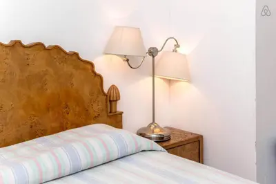 a bedroom with a bed and a lamp on a nightstand at Centro Storico - Piazza di Spagna in Rome