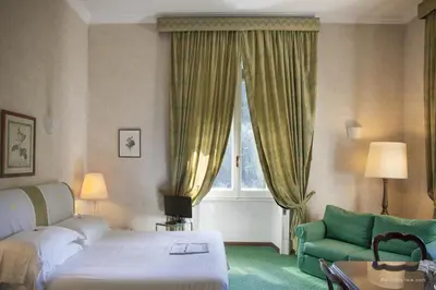 a kitchen and dining room with a table and chairs at Aldrovandi Residence City Suites in Rome