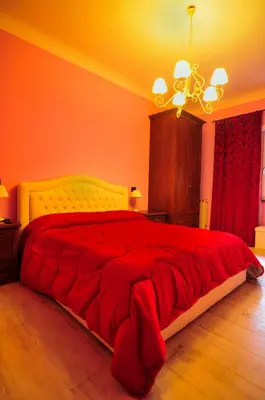 a bedroom with a large bed with a red blanket at Casa Vacanza Katiuscia in Rome