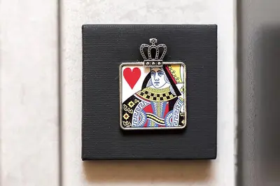 a pin of a queen with a heart on a black box at My Love Suite in Rome