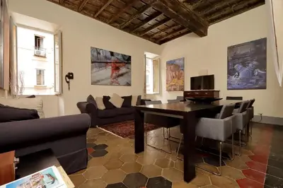a living room with a table and chairs at Monti Charm by the Colosseum in Rome