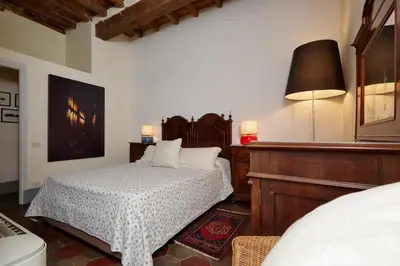 a bedroom with a bed and a table with a lamp at Monti Charm by the Colosseum in Rome