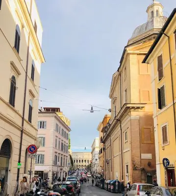 a city street with parked cars and buildings at Monti Charm by the Colosseum in Rome