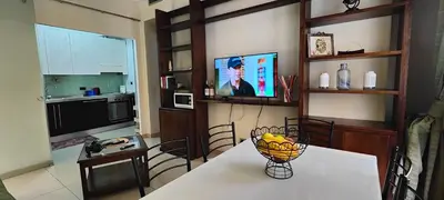 a living room with a couch and a table with chairs at Visconti apartment. in Rome
