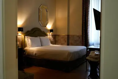 a hotel room with a bed and a desk at The Talent Hotel in Rome