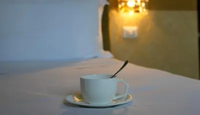 a bedroom with a large bed and a living room at The Talent Hotel in Rome