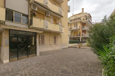 an empty street in front of a building at Il Giardino degli Agrumi - Roma in Rome