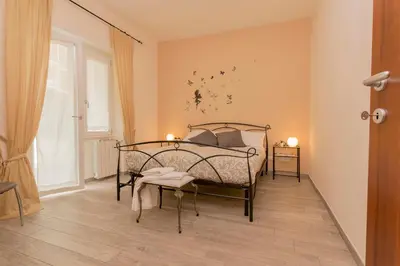 a bedroom with a bed and a chair in it at Il Giardino degli Agrumi - Roma in Rome