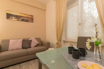 a living room with a couch and a table at Il Giardino degli Agrumi - Roma in Rome