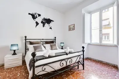 a bedroom with a bed with a world map on the wall at Tasso Street 102 in Rome