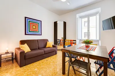 a living room with a couch and a table at Tasso Street 102 in Rome