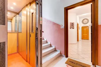 a hallway of a house with a door and stairs at Tasso Street 102 in Rome