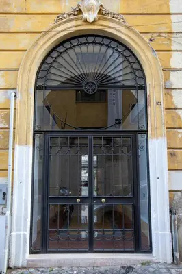 an entrance to a building with a black door at Tasso Street 102 in Rome