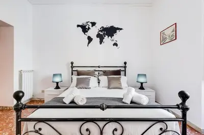a bedroom with a bed with a world map on the wall at Tasso Street 102 in Rome