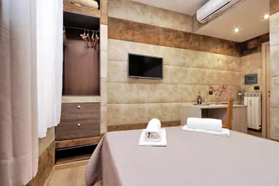 a room with a bed and a tv on a wall at Gialli Vatican Guesthouse in Rome