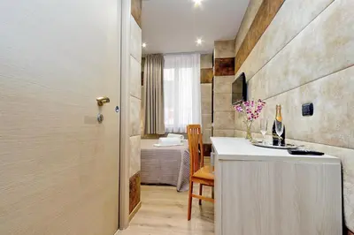 a kitchen with a counter and a table in a room at Gialli Vatican Guesthouse in Rome