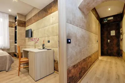 a bathroom with a vanity and a room with a bed at Gialli Vatican Guesthouse in Rome
