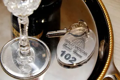 a table topped with a bottle and a glass at Gialli Vatican Guesthouse in Rome