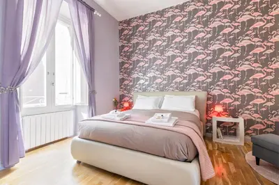 a bedroom with a bed with a floral wallpaper at Rome As You Feel - Vittorio Colorful Design Apartment in Rome