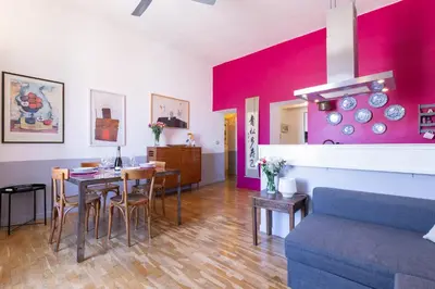 a living room with a table and a couch at Rome As You Feel - Vittorio Colorful Design Apartment in Rome