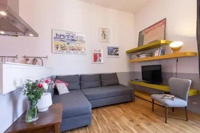 a living room with a couch and a tv at Rome As You Feel - Vittorio Colorful Design Apartment in Rome