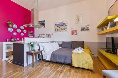 a bedroom with a bed and a desk with a tv at Rome As You Feel - Vittorio Colorful Design Apartment in Rome