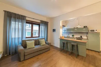 a living room with a couch and a kitchen at Rhome Vintage Holidays San Pietro in Rome