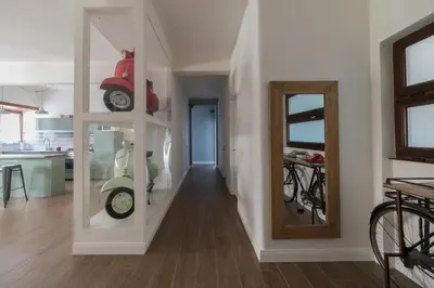 a hallway with a room with a motorcycle on a wall at Rhome Vintage Holidays San Pietro in Rome