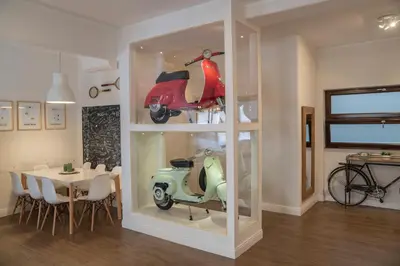 a vespa in a display case in a dining room at Rhome Vintage Holidays San Pietro in Rome