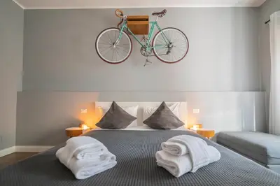 a bedroom with a bed with a bike on the wall at Rhome Vintage Holidays San Pietro in Rome