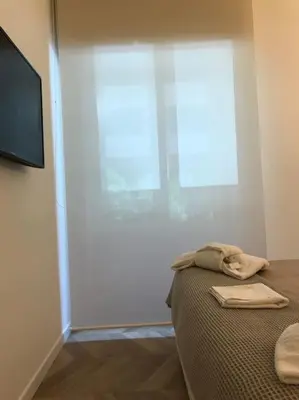 a bedroom with a bed and a large window at THE BREAK - Via Veneto Charming Suite in Rome
