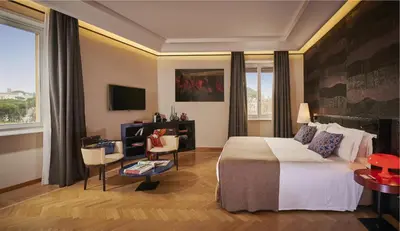 a hotel room with a bed and a table and chairs at 47 Boutique Hotel in Rome