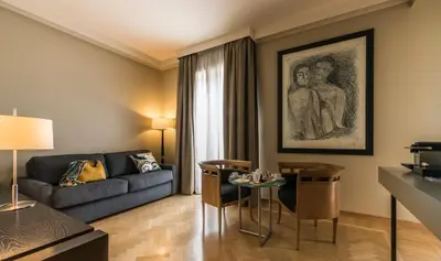 a living room with a couch and a table at 47 Boutique Hotel in Rome