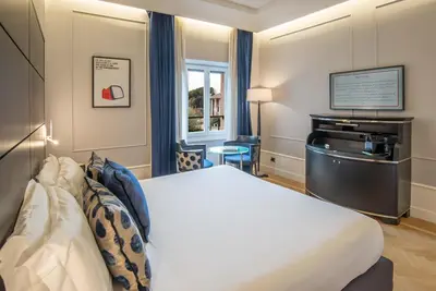 a hotel room with a bed and a desk at 47 Boutique Hotel in Rome