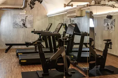 a gym with treadmills and exercise equipment in a room at 47 Boutique Hotel in Rome