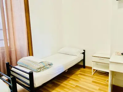 a small room with a bed and a desk at COMFORT INN ROMA TERMINI in Rome