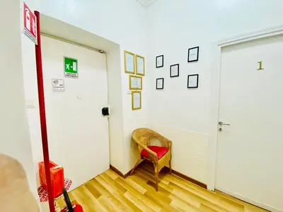 a hallway with a red chair and a door at COMFORT INN ROMA TERMINI in Rome