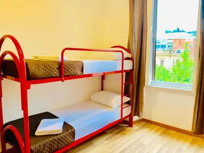 a red bunk bed in a room with a window at COMFORT INN ROMA TERMINI in Rome