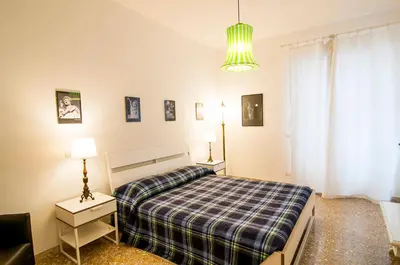 a bedroom with a bed with a checkered blanket at GuestHost - Vatican Museums Cozy Flat x4 in Rome