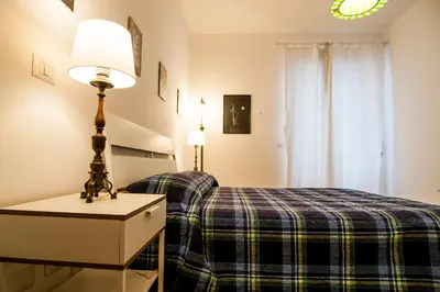 a bedroom with a bed and a lamp on a table at GuestHost - Vatican Museums Cozy Flat x4 in Rome