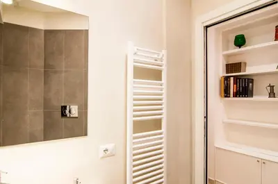 a bathroom with a mirror and a closet at GuestHost - Vatican Museums Cozy Flat x4 in Rome
