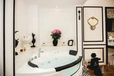 a white bathroom with a tub in a room at PRATI 1930 Boutique apartments Rome in Rome