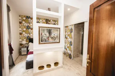 a hallway with a wall with a painting on it at PRATI 1930 Boutique apartments Rome in Rome
