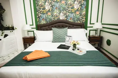 a bedroom with a bed with a green and white blanket at PRATI 1930 Boutique apartments Rome in Rome