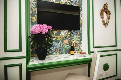 a vase with flowers on a shelf in a room at PRATI 1930 Boutique apartments Rome in Rome