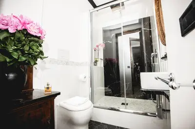 a bathroom with a shower and a toilet and a sink at PRATI 1930 Boutique apartments Rome in Rome