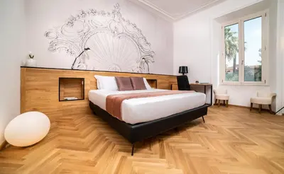 a bedroom with a large bed with a wooden floor at Youroom Abruzzi in Rome